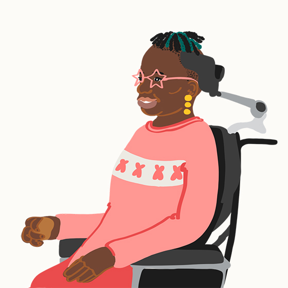Person of colour with star-shaped glasses smiling in a wheel chair
