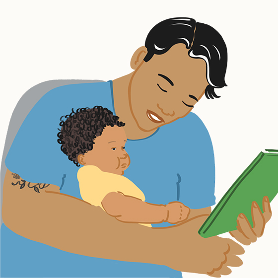 Person holding a baby and a book