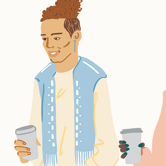 Person wearing a vest and holding a coffee cup
