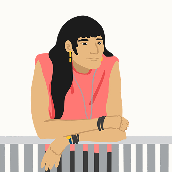 Person with long black hair leaning on a railing