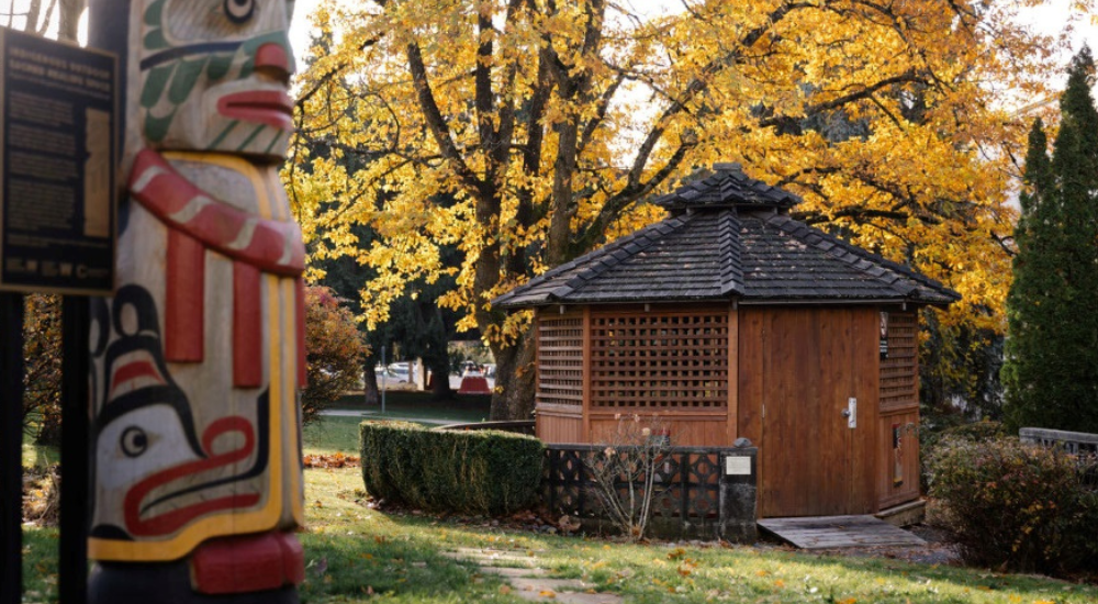 a totem pole next to a gazebo